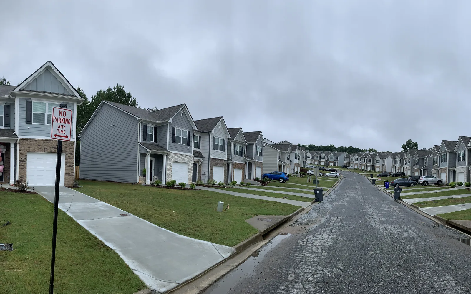 Suburban residential homes on a tree-lined street with consistent architectural character